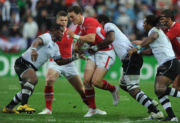 02.10.11 - Wales v Fiji - Rugby World Cup 2011 - George North of Wales is tackled by Wame Lewaravu(R). 