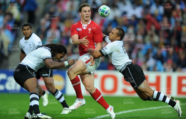 02.10.11 - Wales v Fiji - Rugby World Cup 2011 - George North of Wales is tackled by Vitori Buatava(R) of Fiji. 