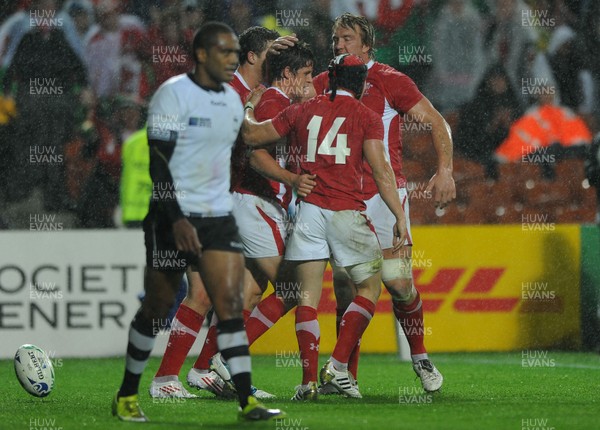 02.10.11 - Wales v Fiji - Rugby World Cup 2011 - Lloyd Williams of Wales celebrates his try with George North, Andy Powell and Leigh Halfpenny. 