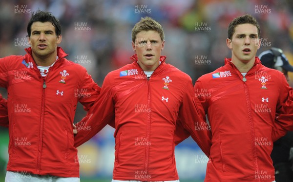 02.10.11 - Wales v Fiji - Rugby World Cup 2011 - Mike Phillips, Rhys Priestland and George North during the national anthems. 