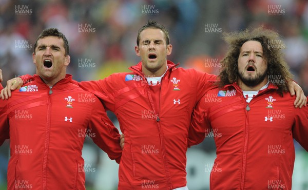 02.10.11 - Wales v Fiji - Rugby World Cup 2011 - Huw Bennett, Lee Byrne and Adam Jones during the national anthems. 