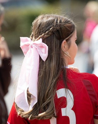 060925 - Wales v Fiji, Women’s Rugby World Cup - Wales fans sport pink bows as they wait for the team to arrive at the stadium ahead of the match