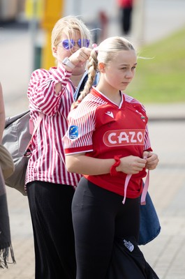 060925 - Wales v Fiji, Women’s Rugby World Cup - Wales fans sport pink bows as they wait for the team to arrive at the stadium ahead of the match
