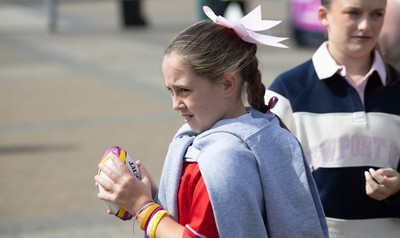 060925 - Wales v Fiji, Women’s Rugby World Cup - Wales fans sport pink bows as they wait for the team to arrive at the stadium ahead of the match