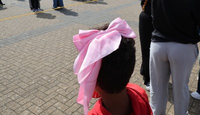 060925 - Wales v Fiji, Women’s Rugby World Cup - Wales fans sport pink bows as they wait for the team to arrive at the stadium ahead of the match
