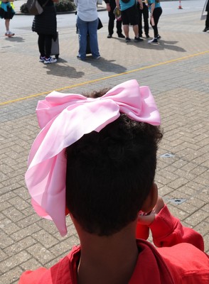 060925 - Wales v Fiji, Women’s Rugby World Cup - Wales fans sport pink bows as they wait for the team to arrive at the stadium ahead of the match