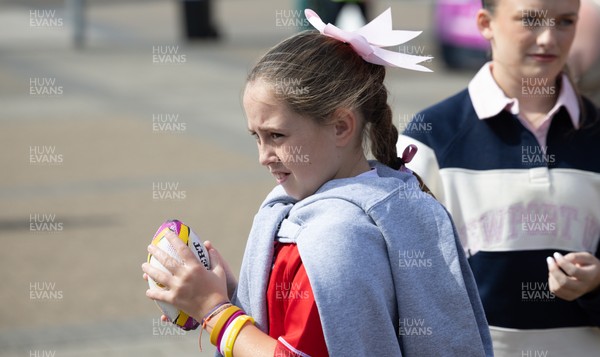 060925 - Wales v Fiji, Women’s Rugby World Cup - Wales fans sport pink bows as they wait for the team to arrive at the stadium ahead of the match