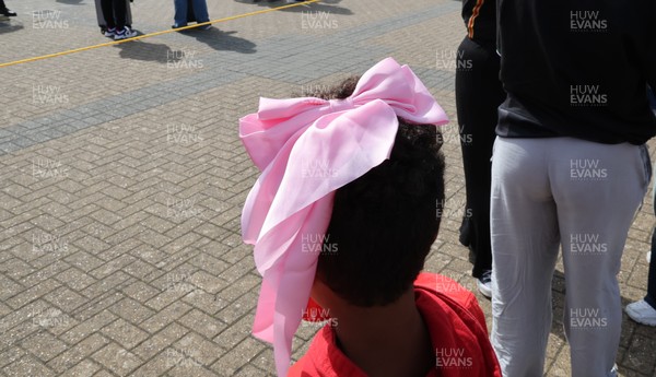 060925 - Wales v Fiji, Women’s Rugby World Cup - Wales fans sport pink bows as they wait for the team to arrive at the stadium ahead of the match