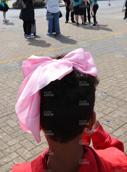 060925 - Wales v Fiji, Women’s Rugby World Cup - Wales fans sport pink bows as they wait for the team to arrive at the stadium ahead of the match