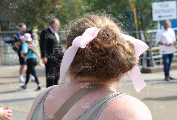 060925 - Wales v Fiji, Women’s Rugby World Cup - Wales fans sport pink bows as they wait for the team to arrive at the stadium ahead of the match
