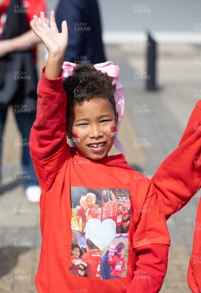 060925 - Wales v Fiji, Women’s Rugby World Cup - Wales fans sport pink bows as they wait for the team to arrive at the stadium ahead of the match