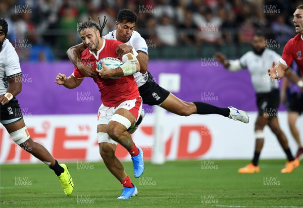 091019 - Wales v Fiji - Rugby World Cup - Pool D - Josh Navidi of Wales is tackled by Ben Volavola of Fiji