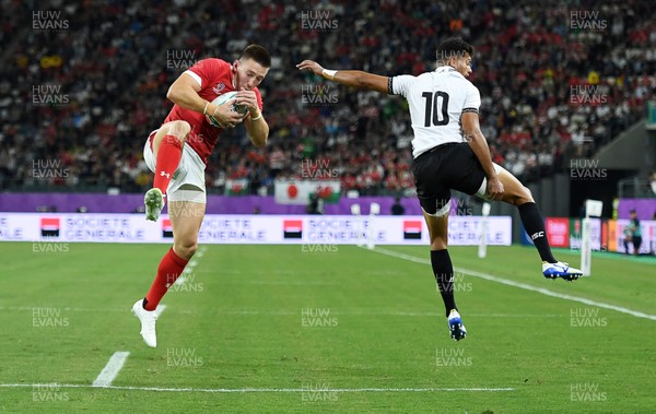 091019 - Wales v Fiji - Rugby World Cup - Pool D - Josh Adams of Wales beats Ben Volavola of Fiji to score a try