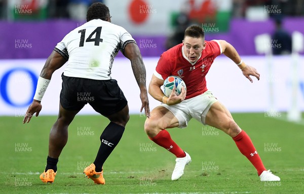 091019 - Wales v Fiji - Rugby World Cup - Pool D - Josh Adams of Wales is challenged by Josua Tuisova of Fiji