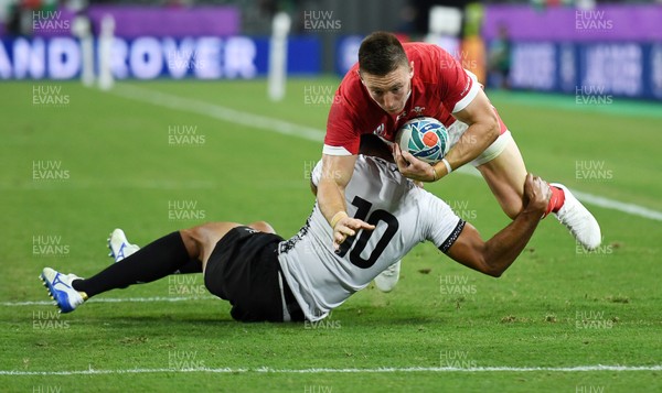 091019 - Wales v Fiji - Rugby World Cup - Pool D - Josh Adams of Wales is tackled by Ben Volavola of Fiji