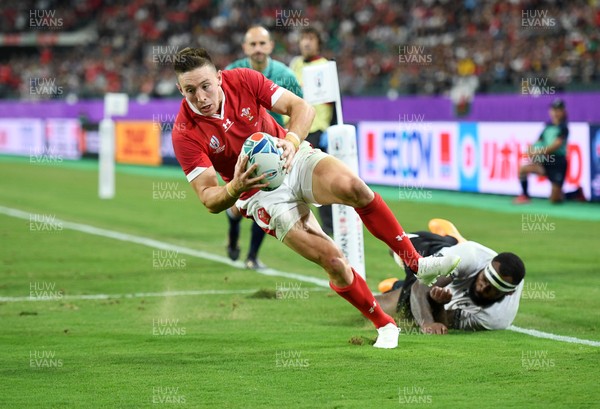 091019 - Wales v Fiji - Rugby World Cup - Pool D - Josh Adams of Wales escapes the tackle of Levani Botia of Fiji to score a try