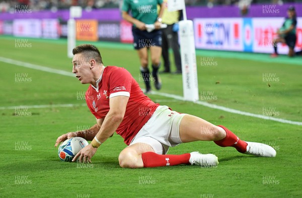 091019 - Wales v Fiji - Rugby World Cup - Pool D - Josh Adams of Wales escapes the tackle of Levani Botia of Fiji to score a try