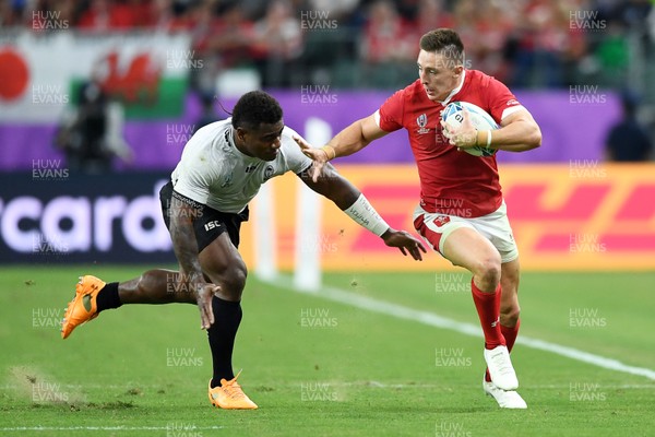 091019 - Wales v Fiji - Rugby World Cup - Pool D - Josh Adams of Wales is tackled by Josua Tuisova of Fiji