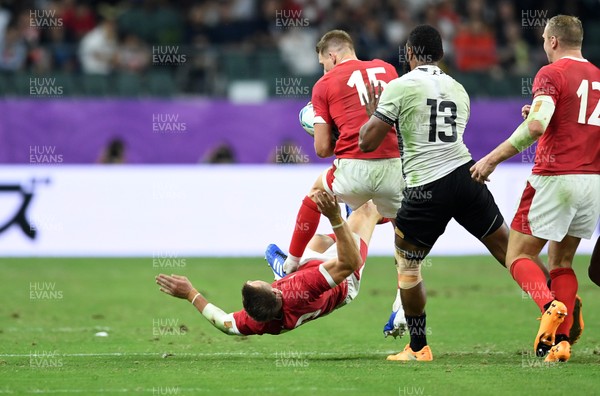 091019 - Wales v Fiji - Rugby World Cup - Pool D - Liam Williams of Wales collides with team mate Dan Biggar in the air, who leaves the field