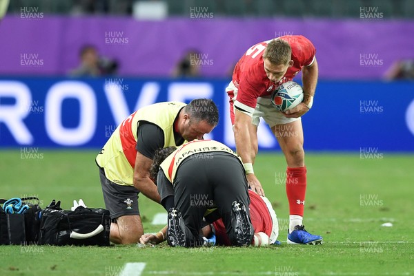 091019 - Wales v Fiji - Rugby World Cup - Pool D - Liam Williams of Wales checks on Dan Biggar after colliding with him in the air