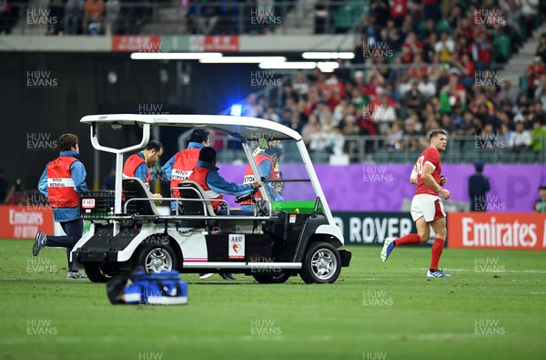 091019 - Wales v Fiji - Rugby World Cup - Pool D - Dan Biggar of Wales runs off the field followed by the medical buggy