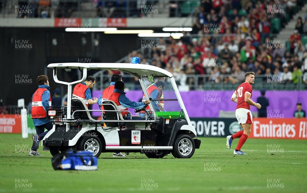 091019 - Wales v Fiji - Rugby World Cup - Pool D - Dan Biggar of Wales runs off the field followed by the medical buggy