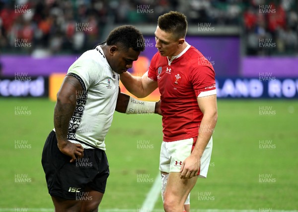 091019 - Wales v Fiji - Rugby World Cup - Josua Tuisova of Fiji and Josh Adams of Wales at the end of the game