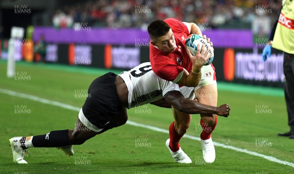 091019 - Wales v Fiji - Rugby World Cup - Josh Adams of Wales is tackled by Frank Lomani of Fiji