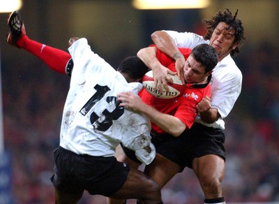 9-11-02. Wales v Fiji.  Wales' Stephen Jones is up-ended by Seru Rabeni (left) and Nicky Little (rt).  Picture: James Davies/