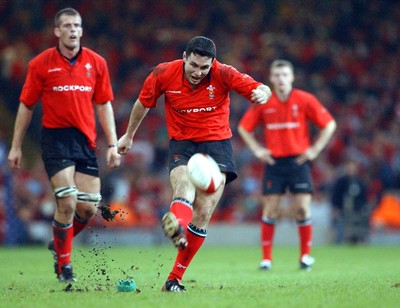 9-11-02. Wales v Fiji.  Wales' Stephen Jones puts more points on the board, watched by Gareth Llewellyn (left) and Dwayne Peel (rt).  Picture: James Davies/