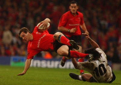 09.11.02  Wales v Fiji  Wales Mark Jones slips tackle by Nicky Little   