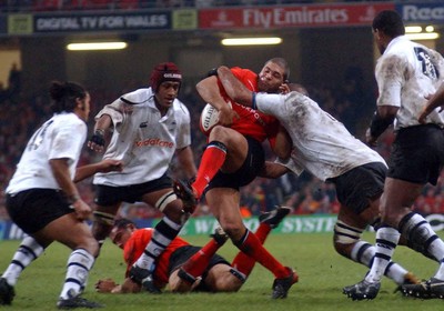 9-11-02 Wales v Fuji  Wales captain Colin Charvis is tackled by Fuji's lock forward Apisai Naevo  