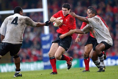 9-11-02. Wales v Fiji.  Wales' Stephen Jones is caught by Apisai Naevo (left) and Seremaia Bai (rt)  Picture: James Davies/