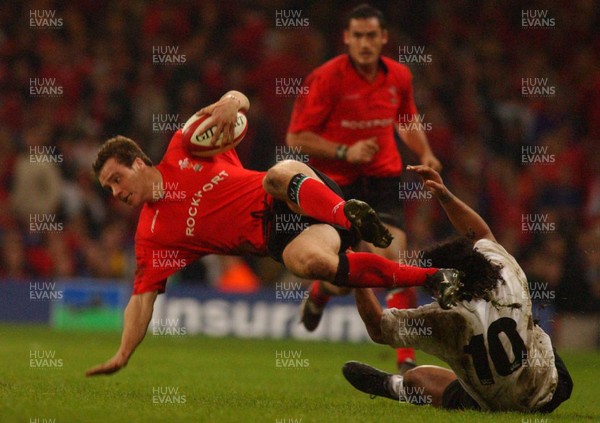 09.11.02  Wales v Fiji  Wales Mark Jones slips tackle by Nicky Little   