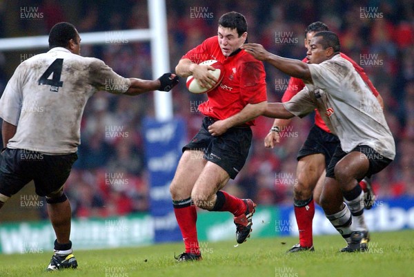 9-11-02. Wales v Fiji.  Wales' Stephen Jones is caught by Apisai Naevo (left) and Seremaia Bai (rt)  Picture: James Davies/