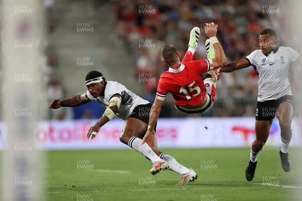 100923 - Wales v Fiji - Rugby World Cup 2023 - Pool C - Liam Williams of Wales is tackled by Vinaya Habosi of Fiji 