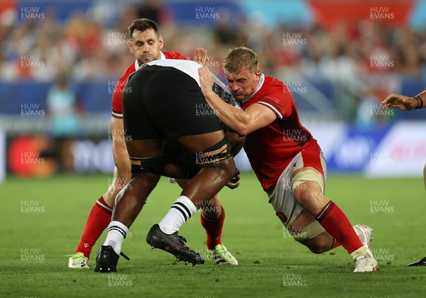 100923 - Wales v Fiji - Rugby World Cup 2023 - Pool C - Temo Mayanavanua of Fiji is tackled by Tomos Williams and Jac Morgan of Wales 