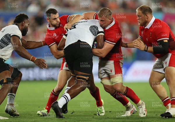 100923 - Wales v Fiji - Rugby World Cup 2023 - Pool C - Temo Mayanavanua of Fiji is tackled by Tomos Williams and Jac Morgan of Wales 
