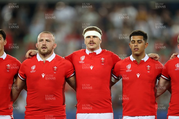 100923 - Wales v Fiji - Rugby World Cup 2023 - Pool C - Dillon Lewis, Aaron Wainwright and Rio Dyer of Wales sing the anthem