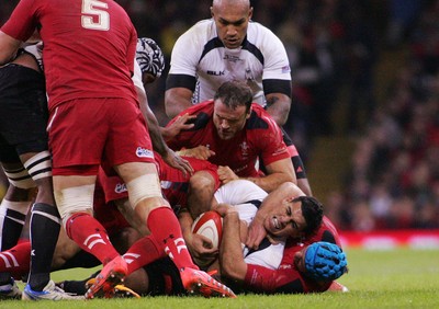 151114 - Wales v Fiji - Dove Men+Care Series - Josh Matavesi of Fiji is wrapped up by Justin Tipuric of Wales