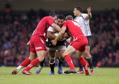 151114 - Wales v Fiji - Dove Men+Care Series - Jerry Yanuyanutawa of Fiji is tackled by Scott Baldwin(L) and Rhys Priestland of Wales