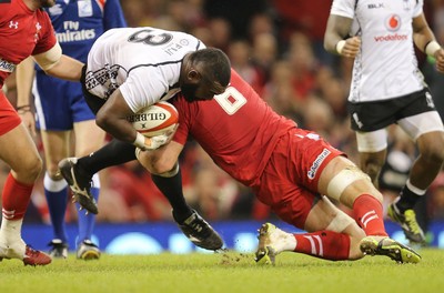 151114 -  Wales v Fiji, Dove Men Series 2014, Cardiff - Manasa Saulo of Fiji is tackled by Dan Lydiate of Wales 