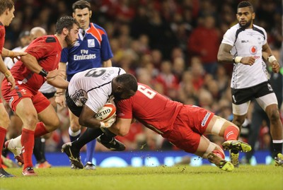 151114 -  Wales v Fiji, Dove Men Series 2014, Cardiff - Manasa Saulo of Fiji is tackled by Dan Lydiate of Wales 