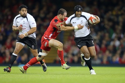 151114 -  Wales v Fiji, Dove Men Series 2014, Cardiff - Akapusi Qera of Fiji is tackled by Jamie Roberts of Wales  