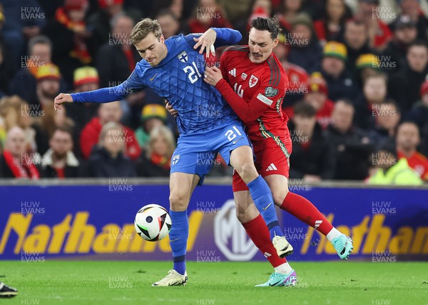210324 - Wales v Finland, Euro 2024 qualifying play-off semi-final - Daniel Hakans of Finland and Connor Roberts of Wales compete for the ball