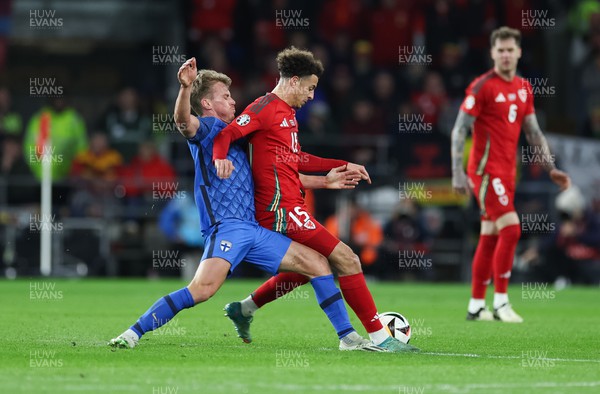 210324 - Wales v Finland, Euro 2024 qualifying play-off semi-final - Ethan Ampadu of Wales is tackled by Rasmus Schuller of Finland