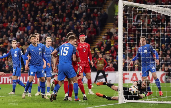 210324 - Wales v Finland, Euro 2024 qualifying play-off semi-final - Finland goalkeeper Lukas Hradecky fails to keep the ball out as Ben Davies of Wales looks to have scored, only for the goal to be ruled out after a VAR check