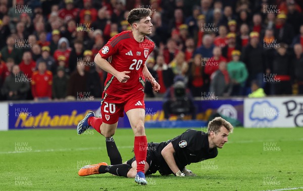 210324 - Wales v Finland, Euro 2024 qualifying play-off semi-final - Finland goalkeeper Lukas Hradecky is beaten by Daniel James of Wales to score the fourth goal