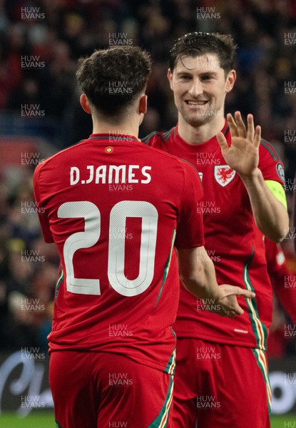 210324 - Wales v Finland, Euro 2024 qualifying play-off semi-final - Daniel James of Wales celebrates with Ben Davies after scoring the fourth goal