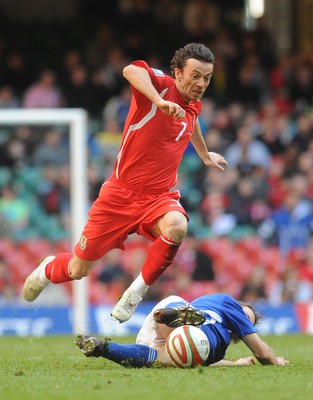 28.03.09 - Wales v Finland, FIFA World Cup 2010 Qualifying Group 4 -  Wales' Simon Davies is brought down by a tackle from Finland's Markus Heikkinen 